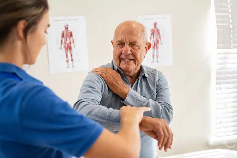 A woman checking an old man's shoulder injury | Regenerative Medicine