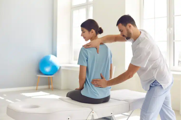 A woman getting a physical therapy from a man