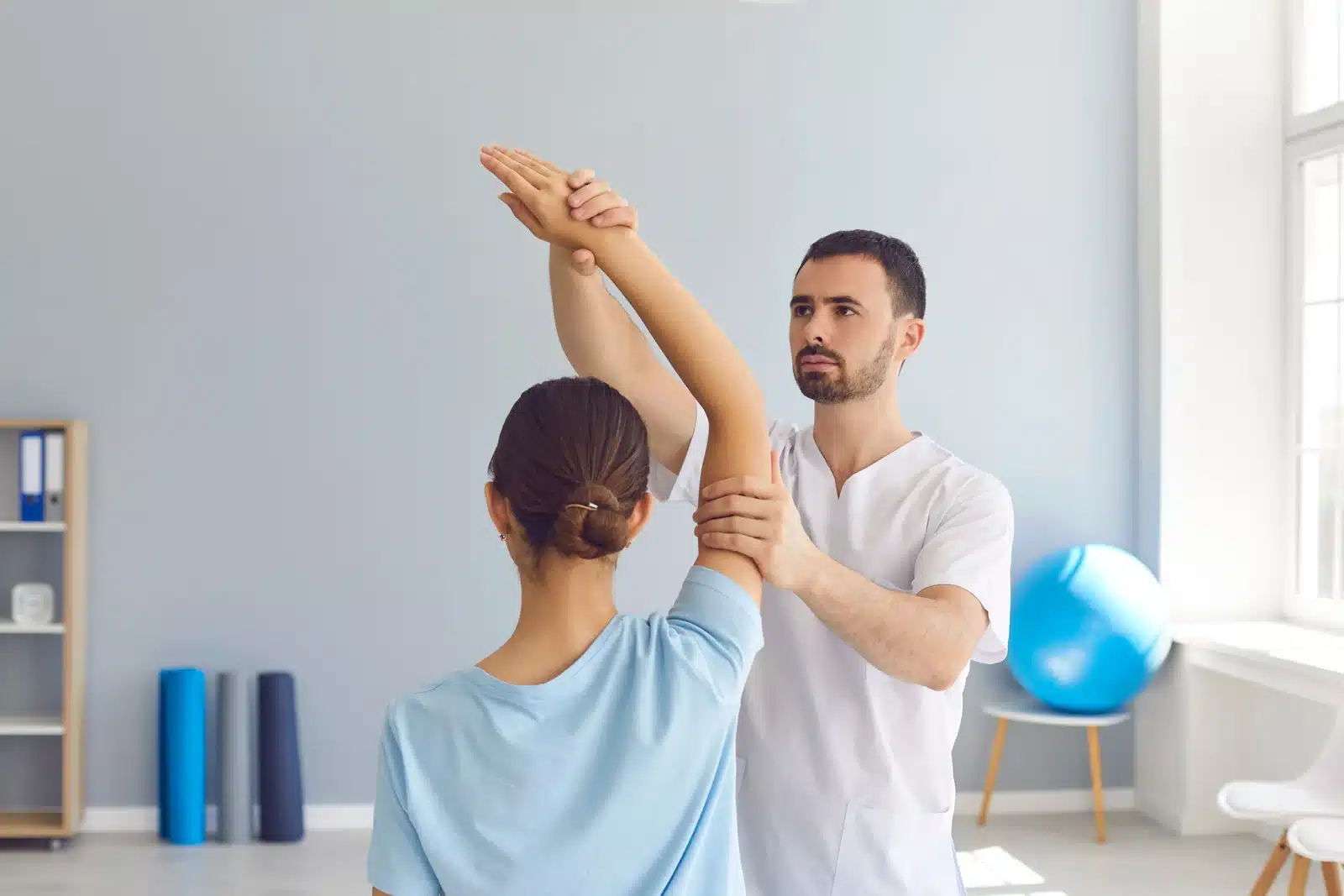 A man doing a physical therapy to a woman | Better Care