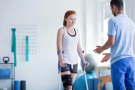 Doctor doing a guide for an injured woman