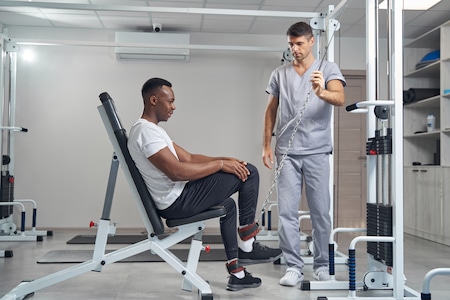 A chiropractor checks the shoulder of an old woman at Better Care Chiropractic and Physical Therapy in Montgomery and Willis