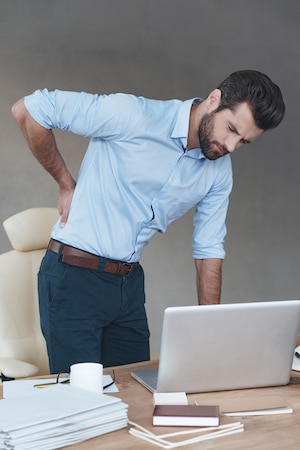 Man having a back pain in the office