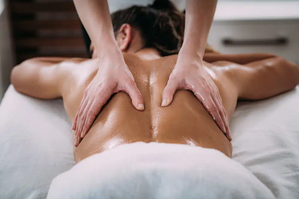 physical therapist doing rehabilitative massage to patient