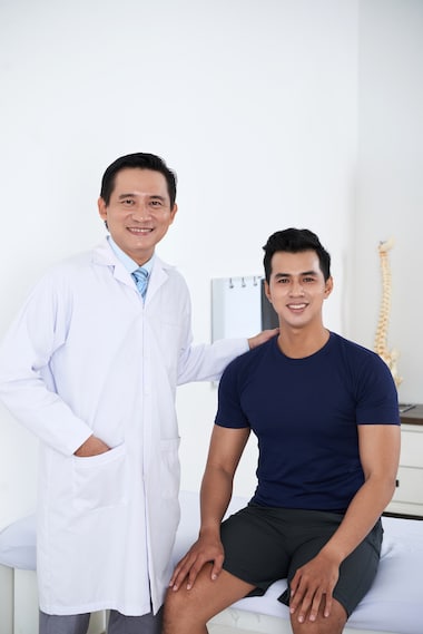 A doctor will do a chiropractic care treatment to his patient
