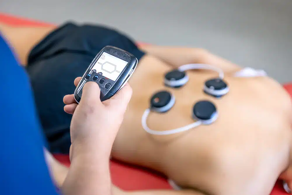EMS Session Electrical Muscle Stimulation adjusting the intensity