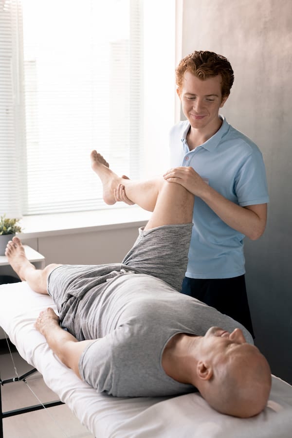 a man receiving chiropractic therapy for joint pain