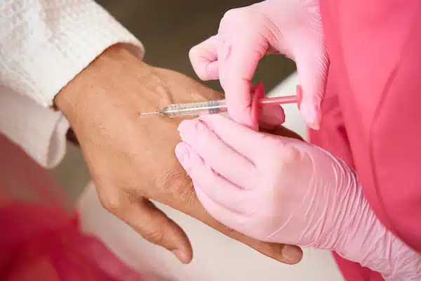 trigger point injetion applied on woman's hand