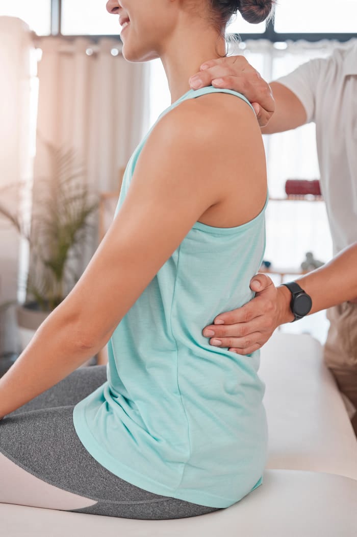 woman receiving chiropractic care and sciatica treatment