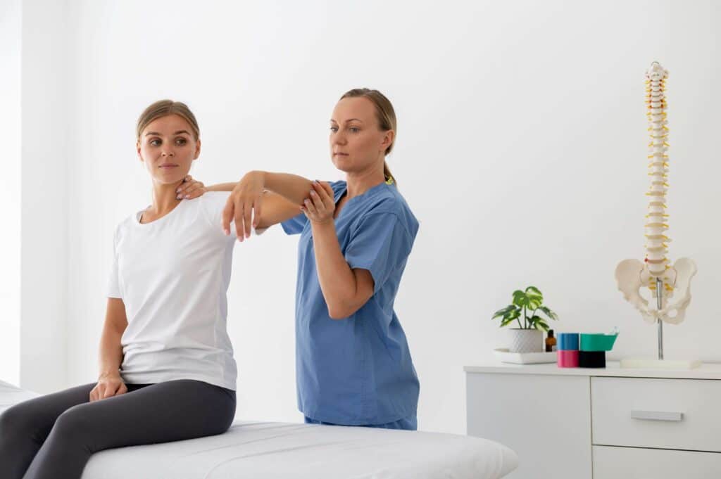 Physiotherapist helping a young female patient in her clinic