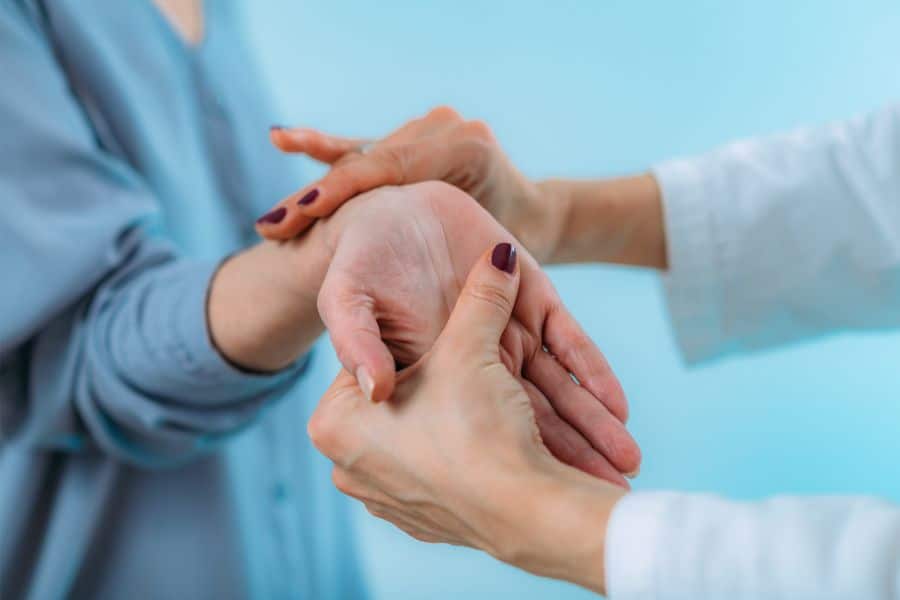 A chiropractor checks the shoulder of an old woman at Better Care Chiropractic and Physical Therapy in Montgomery and Willis