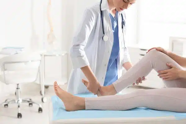 A chiropractor checks the shoulder of an old woman at Better Care Chiropractic and Physical Therapy in Montgomery and Willis