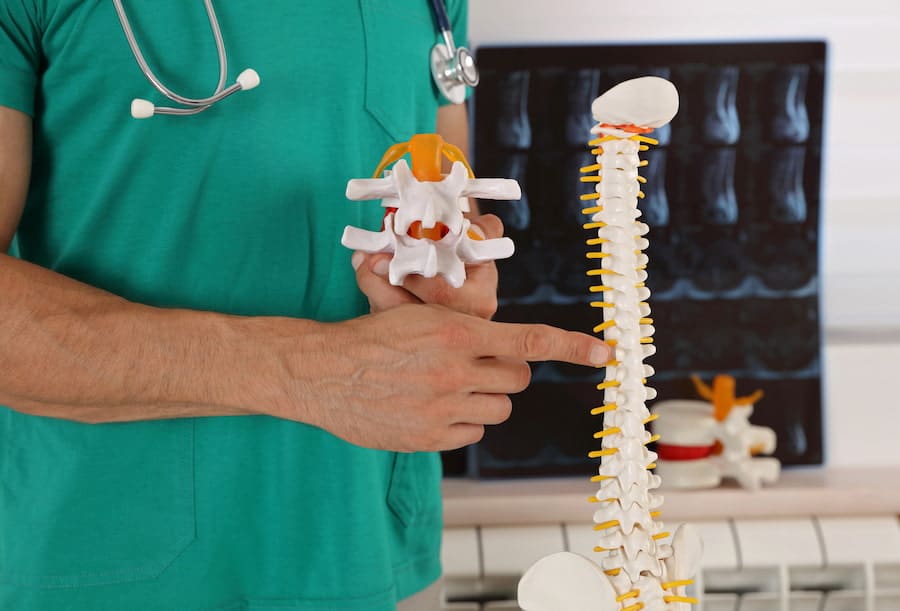 A chiropractor checks the shoulder of an old woman at Better Care Chiropractic and Physical Therapy in Montgomery and Willis