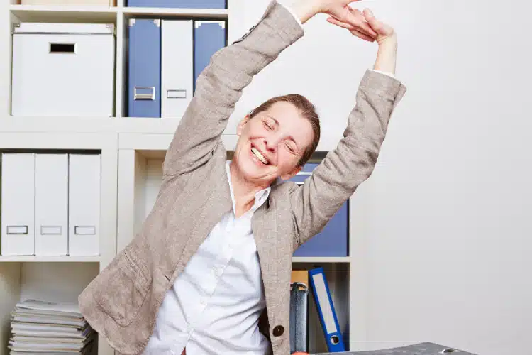 Office worker stretching to relieve muscle tension and improve flexibility after prolonged sitting.