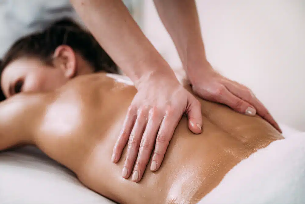 Therapeutic massage targeting back muscles to relieve pain and reduce muscle tension.